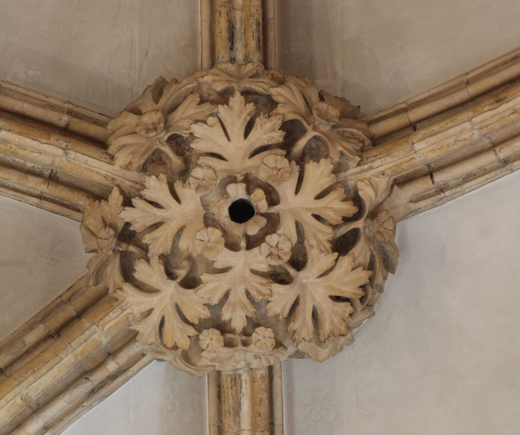 Image of boss in the east crossing at Lincoln Cathedral showing hawthorn in flower
