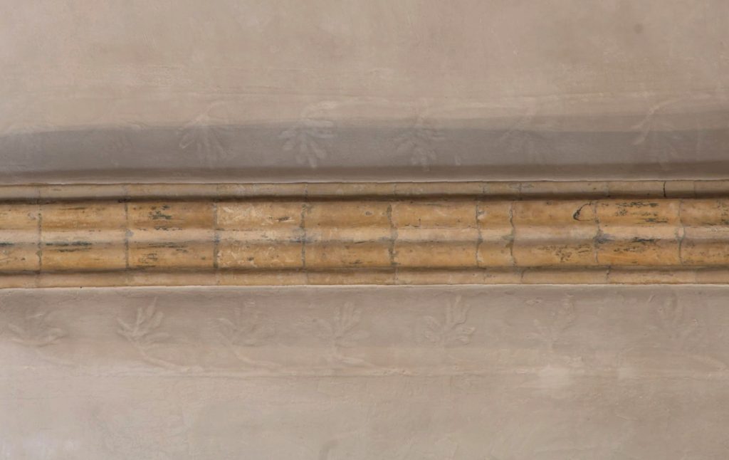 Image of longitudinal ridge rib in east crossing vault at Lincoln Cathedral, showing marks of flanking scrollwork in the plaster on either side of the rib