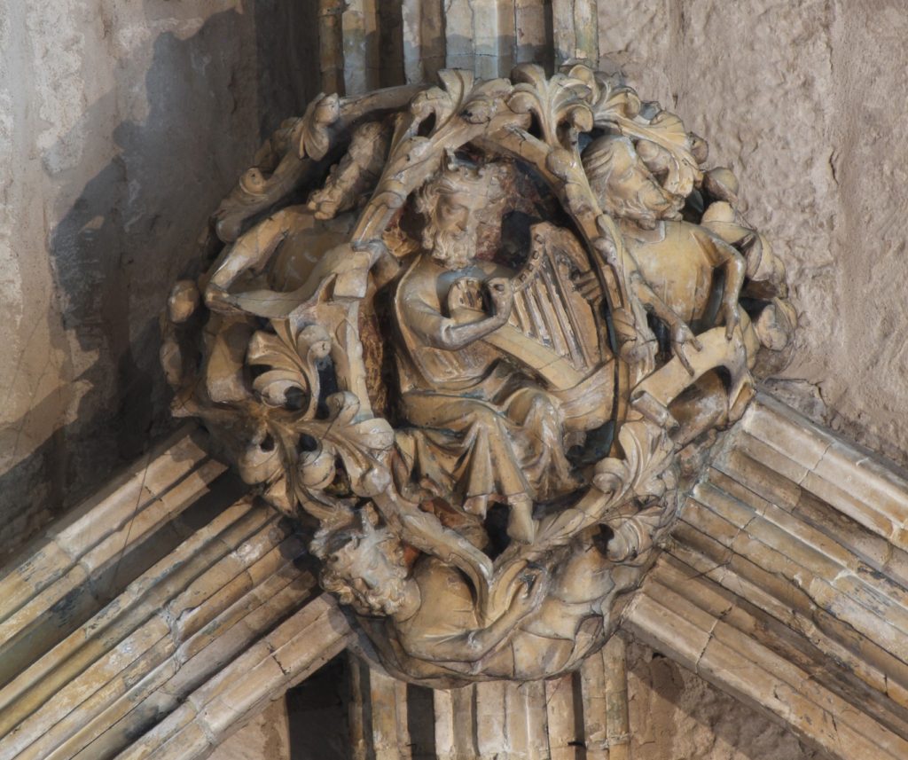 Image of boss in the Angel Choir aisle at Lincoln Cathedral, showing King David playing a harp