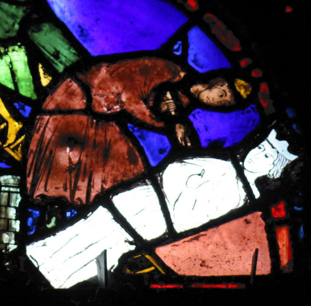 Image of a mason at work from the base panels of the St Cheron window at Chartres Cathedral